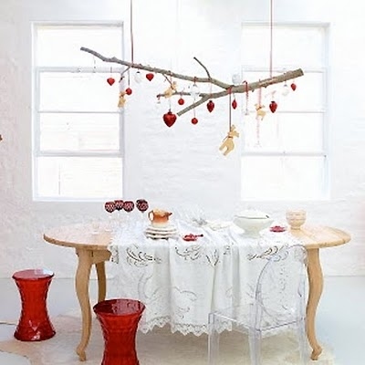 For the holidays, hang Christmas ornaments. But you could also wrap string lights around it for a makeshift chandelier.