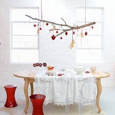 For the holidays, hang Christmas ornaments. But you could also wrap string lights around it for a makeshift chandelier.