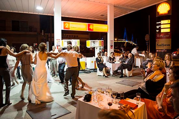 Photographer Nick Hannes stumbled upon an unusual sight while visiting Greece — a wedding at a gas station. To cut costs, Anna and Christos Karalis held their reception at the station owned by the groom, where they danced the night away with their friends and family. A family member told Hannes, “This is how we respond to the crisis ... A Greek keeps on laughing and celebrating, even when his money is being taken away.