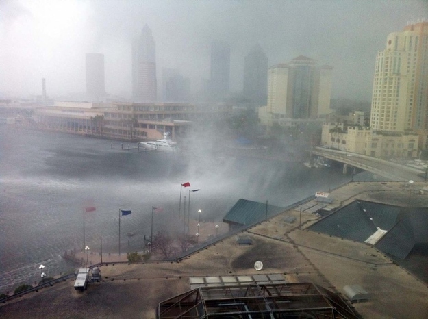 In this photo made available by Dr. Robert Seigel, a waterspout comes ashore in downtown Tampa, Fla., Tuesday Feb. 26, 2013. The National Weather Service warned of a risk of severe weather as a cold front moved across west-central and southwest Florida.