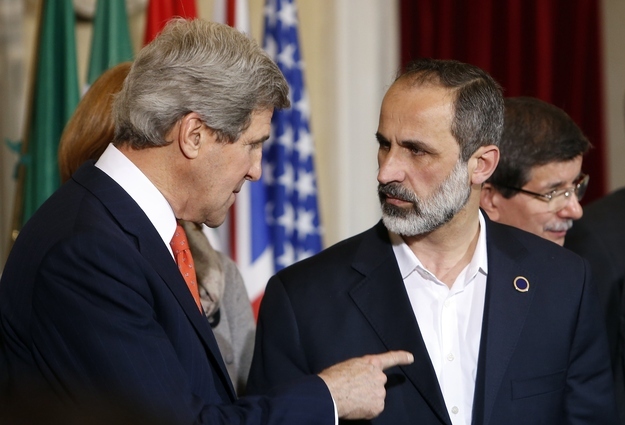 U.S. Secretary of State John Kerry (L) talks with New Syrian National Coalition head Mouaz al-Khatib during a meeting at Villa Madama in Rome, Feb. 28, 2013.