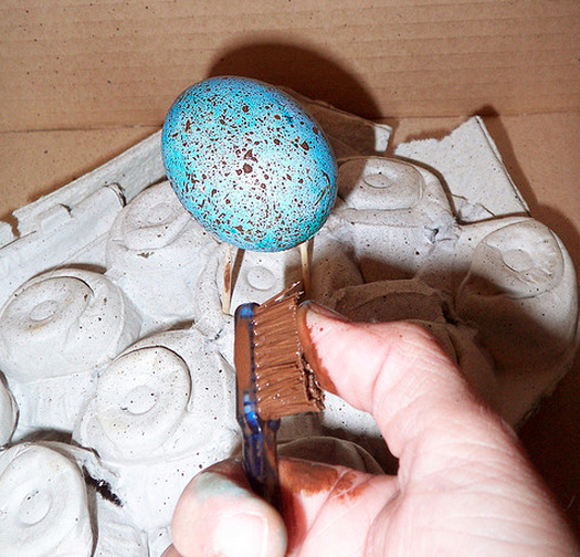 Use a toothbrush to make speckled eggs.