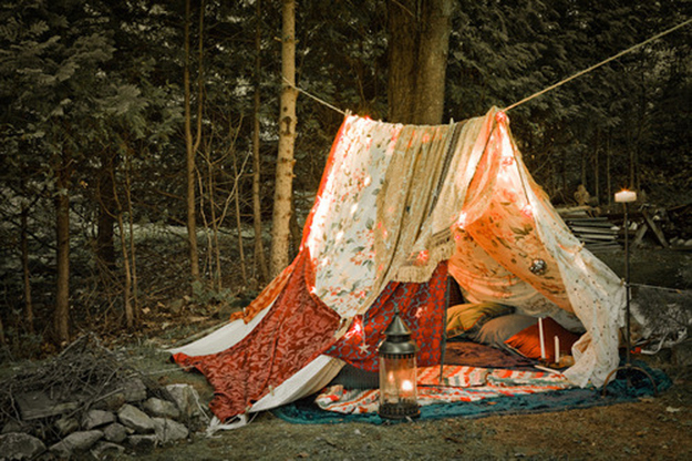 Make a simple canopy by stringing a rope between two trees and hanging sheets off of it.