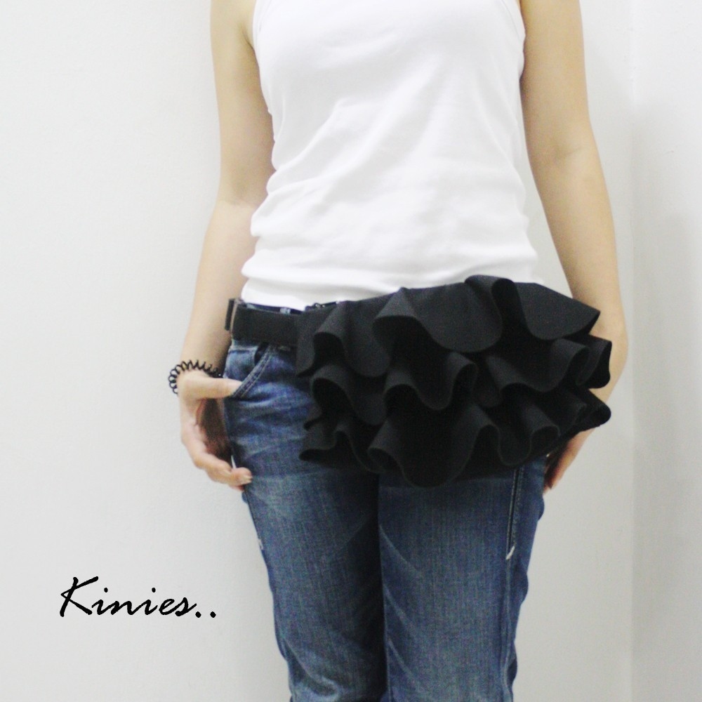 If you are going to wear a fanny pack why not start off bold-- now that's what I call ruffled. Take a plain belted bag and glue some fabric on, pleated and layered.