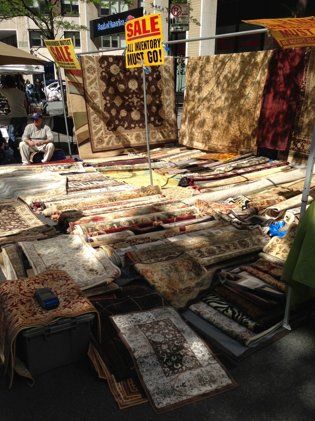 Don't forget! All Inventory Must Go! I can only imagine how many times these rugs have been dragged through the city.