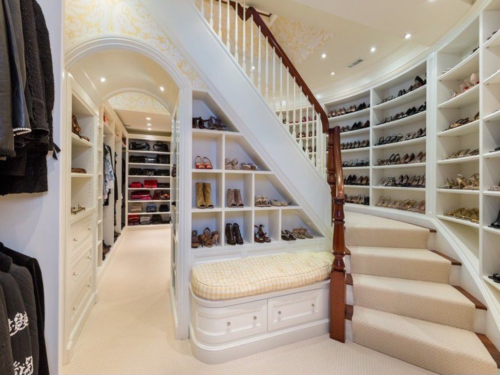 A two-story closet filled with two stories of shoes.