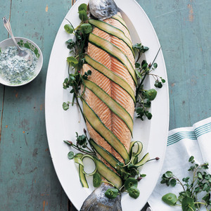 Poach a whole salmon (always impressive) and garland it with ribbons of English cucumber and peppery cress. A sauce of sour cream, cucumber, cress and capers adds a burst of rich tang.