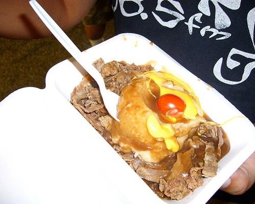 Location: Indiana State Fair 2010Hot Beef Sundae: Marinated beef. Mashed potatoes. Gravy. Cheese. Even topped with a cherry (tomato, that is...). Think of all the burly Midwest men ordering this, taking a bite, and then nodding to themselves contently, saying, "This is how we DO."