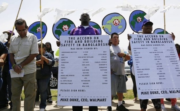 Protesters sing in commemoration of those killed in recent clothing factory tragedies in Bangladesh outside Wal-Mart Stores Inc. headquarters in Bentonville, Arkansas.
