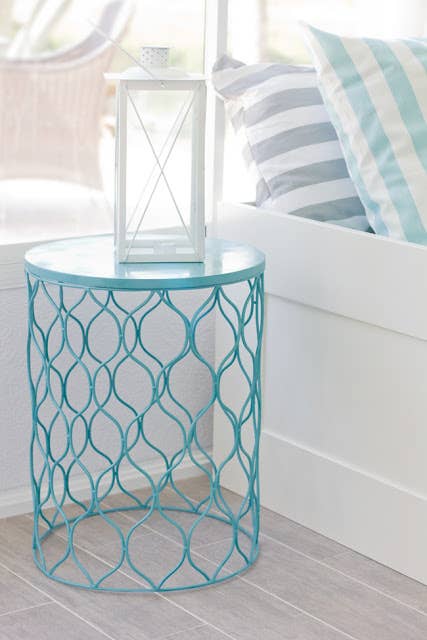 If you&#x27;re not allowed to bring in extra furniture, spray paint an inexpensive wastebasket in the color of your choice, flip it upside down, and use as a bedside table.
