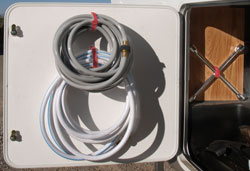 Velcro holding garden hoses attached to the door of an RV