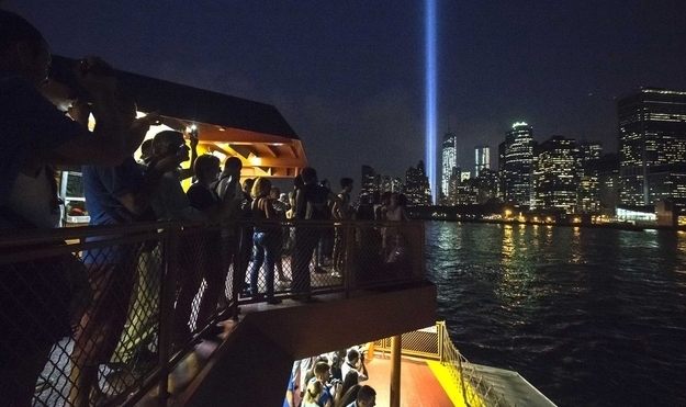 Commuters look out at the Tribute in Light from the Staten Island Ferry.