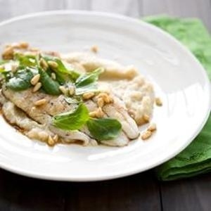 Lay pan-seared fish fillets over silky fennel-garlic puree, then douse with a sprightly pine-nut-balsamic dressing.