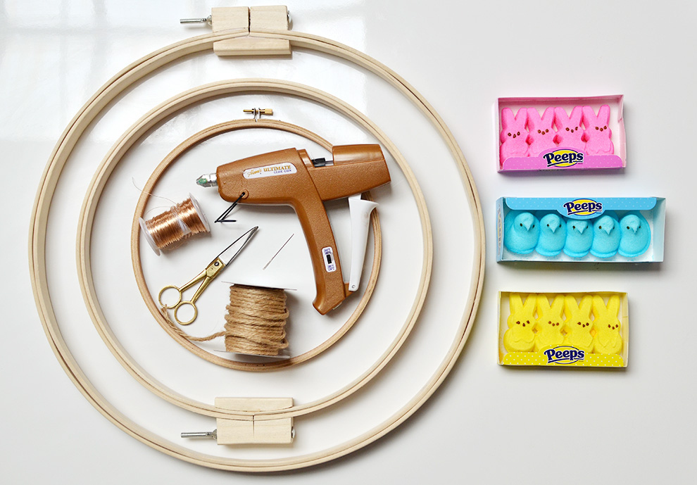- 2 or 3 large embroidery/quilting hoops; we used 20", 14", and 10" hoops.- Twine- Thin jewelry wire- Scissors- A hot glue gun (preferably cordless, since this project can get real tangly real fast)- A large yarn needle- More Peeps than you've ever seen in your life (we used about 100 total and found that the bunnies, rather than the more traditional birds, seemed to stick to the balsa wood better)
