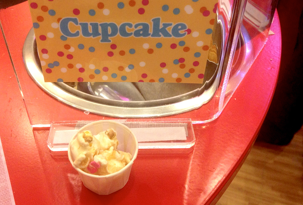 I know! From the fine folks at Popcornopolis, it's actually just popcorn coated in white chocolate and sprinkles, but it sure does taste like a cupcake.