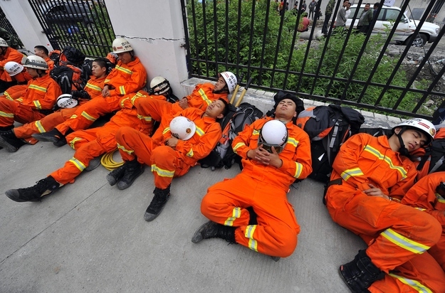 Rescuers nap during a break.