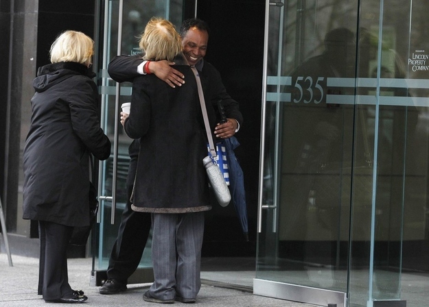 Security guard Manuel Vicente hugs employees as they are allowed to return to Boylston Street for the first time.