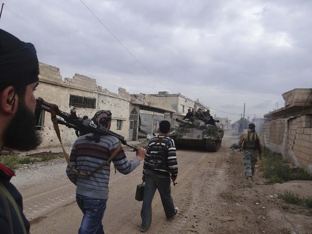 Free Syrian Army fighters move toward the front line in Deraa.