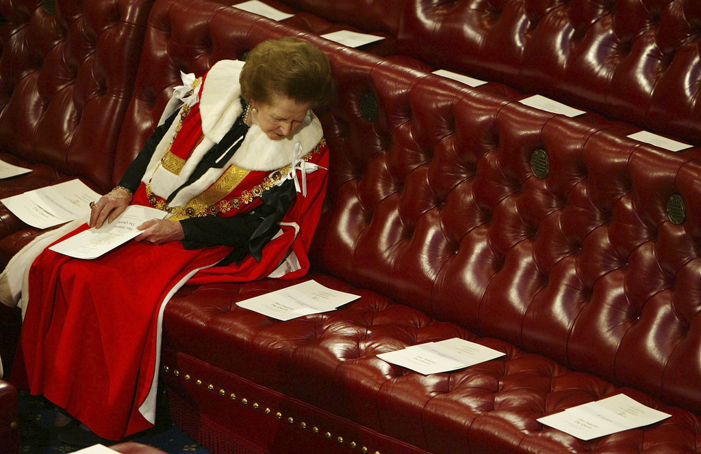 Thatcher is surrounded by empty seats as she waits for Queen Elizabeth to deliver a speech at the State Opening of Parliament in the House of Lords, November 2002.In 1992, Queen Elizabeth names the former prime minister Baroness Margaret Thatcher of Kesteven, a member of the unelected House of Lords with a lifetime title. She stays involved in Conservative politics and delivers speeches for the next ten years, until she suffers a series of small strokes in 2002 and is advised to stop speaking in public.