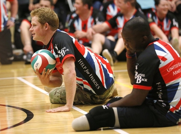 Britain's Prince Harry plays sitting volleyball with the United Kingdom team at a visit to the Warrior Games opening, Saturday, May 11, 2013 in Colorado Springs, Colo. The Warrior Games is a Paralympic-style competition featuring injured servicemen and women from the U.S., United Kingdom, Canada and Australia.