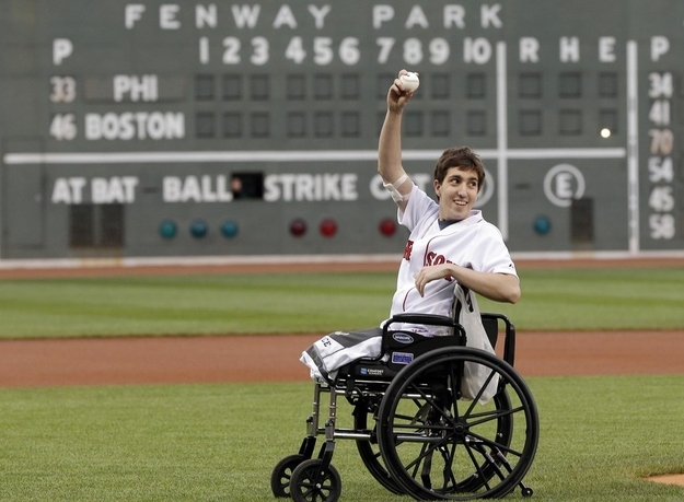 Jeff Bauman acknowledges cheering fans before throwing out the ceremonial first pitch at Fenway Park.