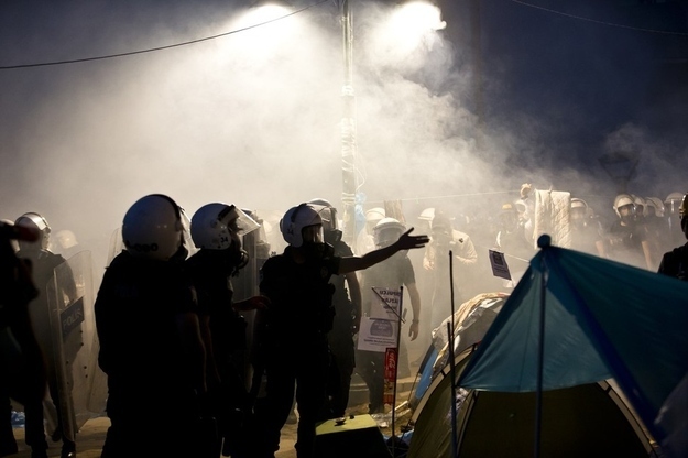 Riot police gather in a tear gas-engulfed Gezi Park in Istanbul.