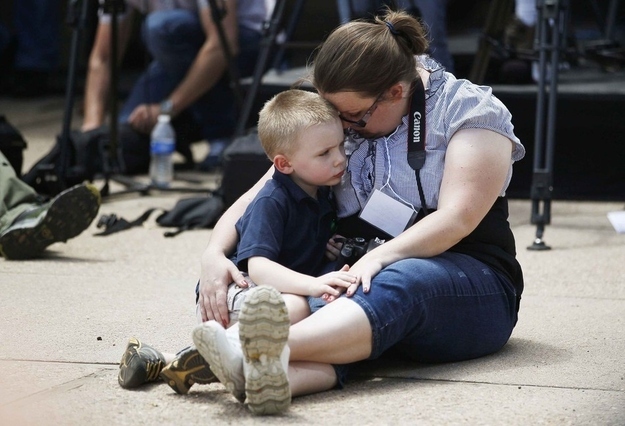Rose Richards, with her son Jake, listens to a names of gun violence victims.