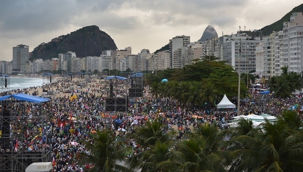 Young people gather at Rio de Janeiro's iconic Copacabana beachfront for the welcoming of Pope Francis to World Youth Day ceremonies.