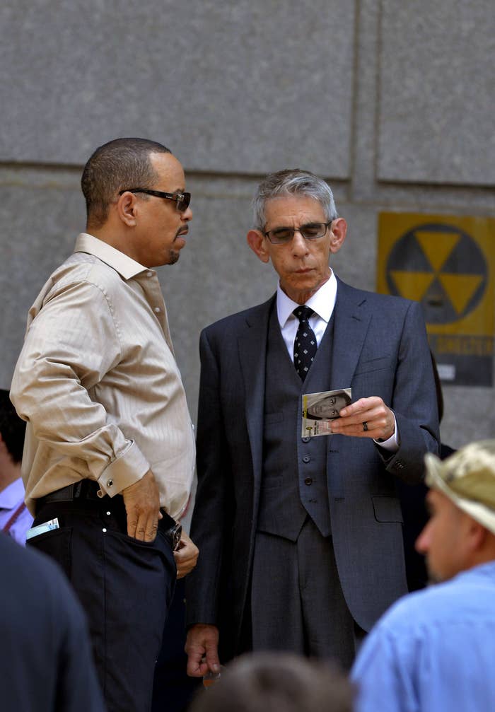Ice-T speaking to Richard Belzer, who is holding a card with Trayvon Martin on the back.
