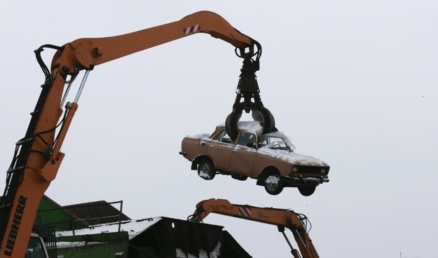 A crane processes a car at Vtormet scrappage plant outside Moscow, January 30, 2013.