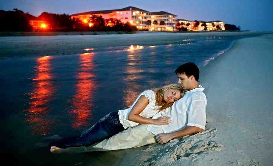 couple in full clothes laying in ocean