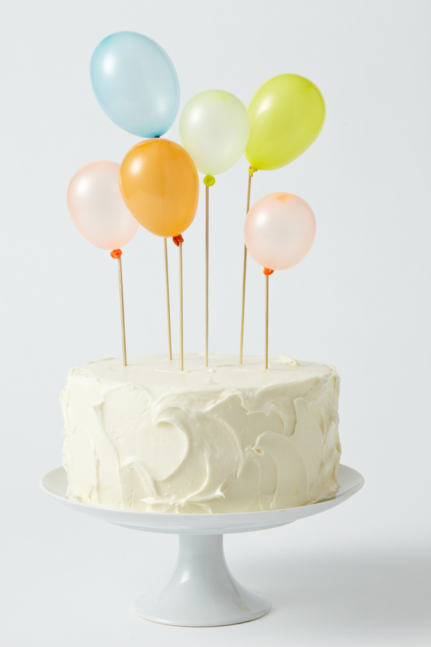 Tie tiny adorable balloons to skewers and stick &#39;em in the cake.