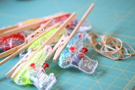 Alter some regular old squirt guns into sweet rubber band guns.