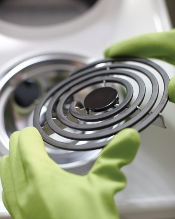 Remove the electric coils and the reflector dishes — you can use a mild cleanser like Bon Ami on the dishes, but use only water on the coils. Get full instructions from Martha Stewart.