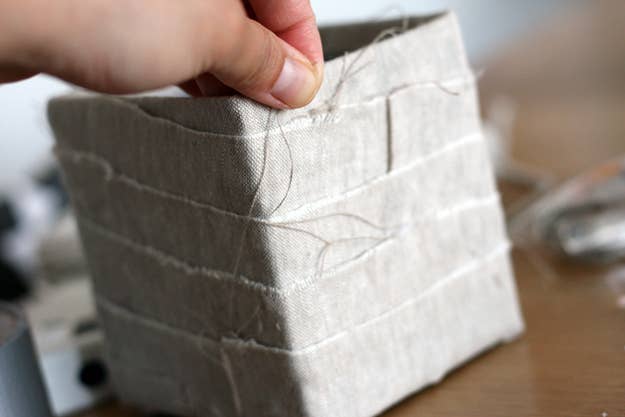 Now that the box is complete, use an X-Acto knife to cut a hole into each of the four corners of the box 1 cm from the top.