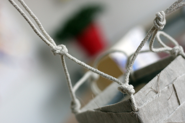 Repeat the same process. Gather one strong from one knot and one string from the knot beside it and knot those two together. Repeat with other 3 sides.