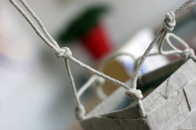 Repeat the same process. Gather one strong from one knot and one string from the knot beside it and knot those two together. Repeat with other 3 sides.