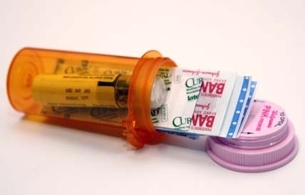 Pack a mini first-aid kit into an old prescription bottle or Altoids tin.