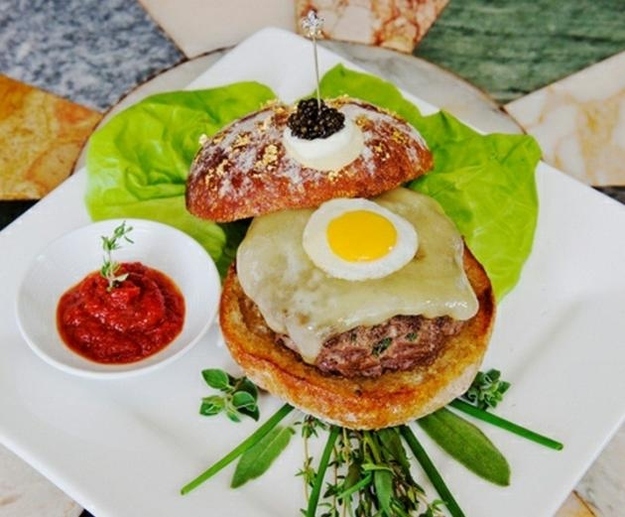 $295 will get you a Waygu beef burger with a fried quail egg, aged cheddar, caviar, black truffles, and gold dust. Only at NYC's Serendipity 3, where you can follow it up with a $1,000 sundae, if you also wipe your butt with money.