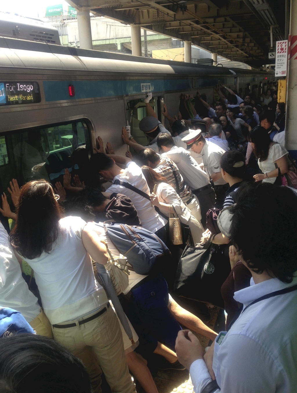 A woman in her 30s slipped and fell into the 20-centimeter gap between the train and the platform during Monday's rush hour in Saitama near Tokyo. After a public announcement about the trapped woman, around 40 passengers helped the railway staff push the 32-ton train car to rescue her. The amazing act was captured by a local news photographer. The woman was pulled out uninjured to collective cheers, and eight minutes later the train took off. Hurrah for humanity!