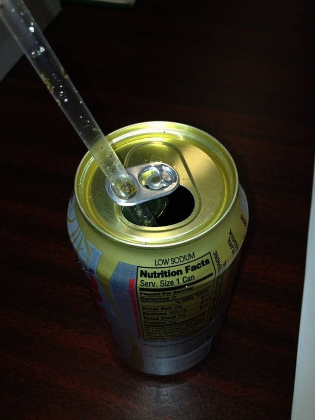 Turn the tab around so that it acts as a holder that can stop the straw from raising out of the can as the soda fizzes.