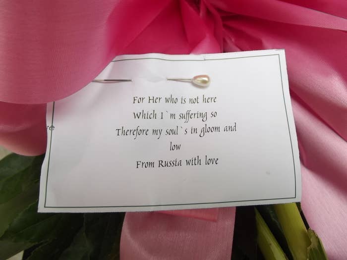 "I think they're from overseas," he said as he positioned two large flower arrangements next to her grave, telling me I could check the cards. He took photographs of the flowers to prove they'd been delivered because sometimes people take out the original cards and replace them, so the real flower-senders don't receive the proper credit. "Scandalous fuckers," he said.He's half-right about the flowers: One of the arrangements seems to be from Russia.