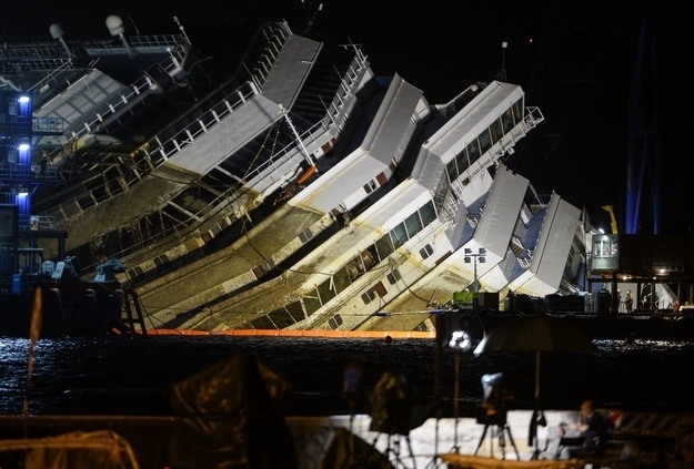 The wreck of Italy's Costa Concordia cruise ship begins to emerge from water on September 17, 2013 near the harbour of Giglio Porto.