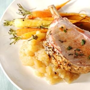 Infuse succulent pork loin with the perfume of garlic and marjoram, then serve over Calvados-enriched apple compote.