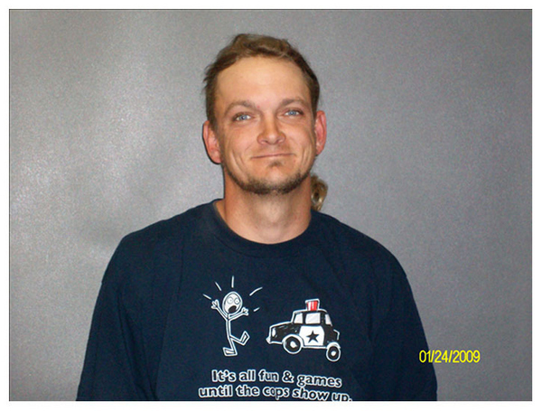 I mean, talk about coming dressed for the ball, Cinderella. "It's all fun and games until the cops show up," is arguably the most poignant mugshot slogan shirt ever. And he knows it, just look at that smirk!