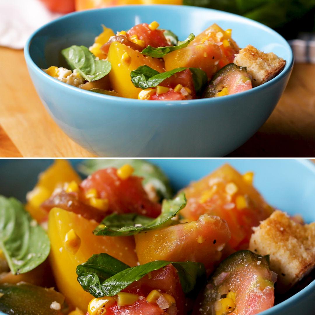 Fresh salad with tomatoes, basil, and croutons in a blue bowl, showcasing vibrant, fresh ingredients