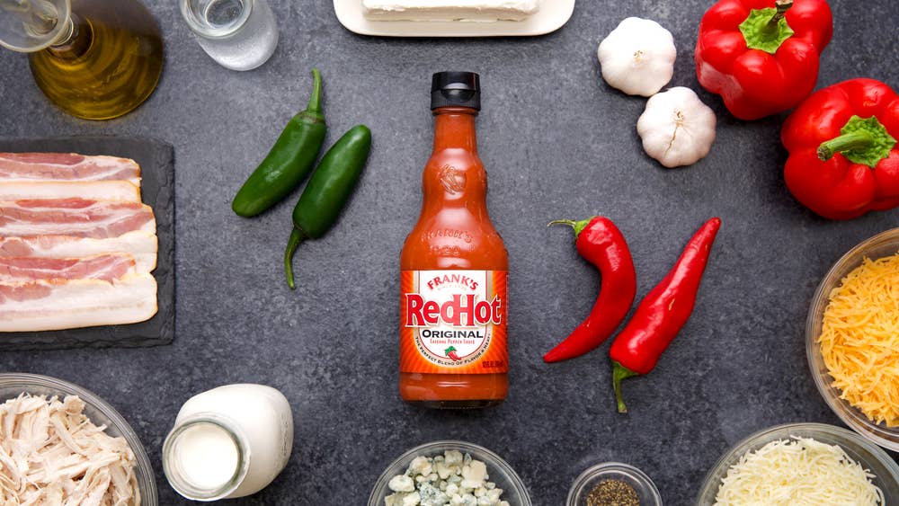 frank's red hot hot sauce on a tabletop surrounded by other recipe ingredients