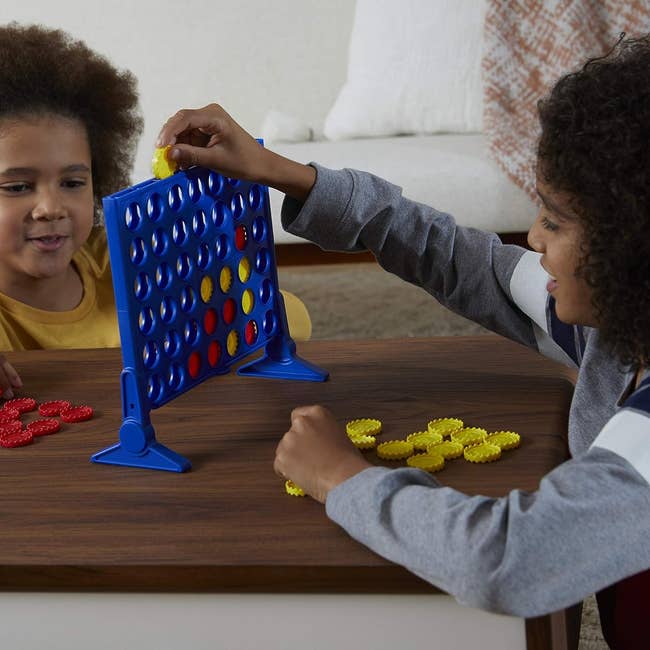 two children playing connect four