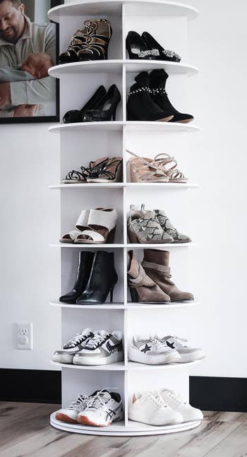 reviewer's white 7-tier tower holding multiple pairs of shoes