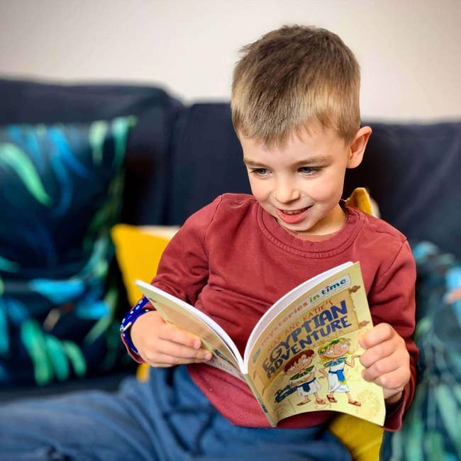 a child reading an adventure book on Egypt